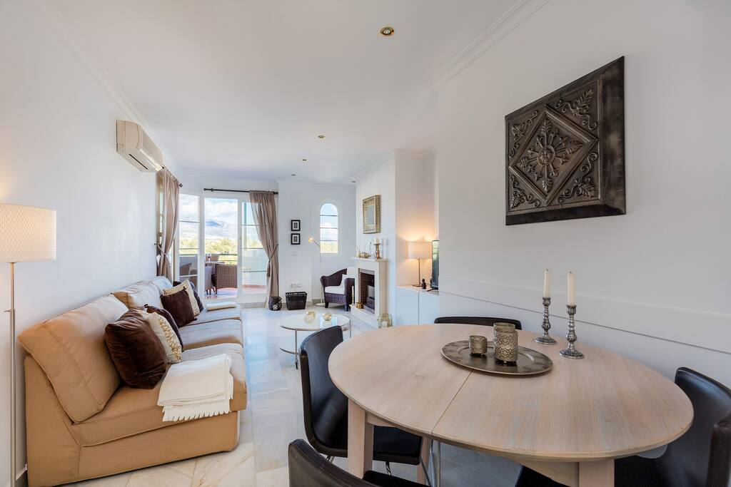 Ample and well appointed living room with fireplace apartment with sea views for rent by Puerto banus with pool