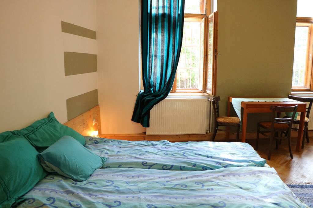 windows of the bedroom open to the Gül Baba Mosque garden