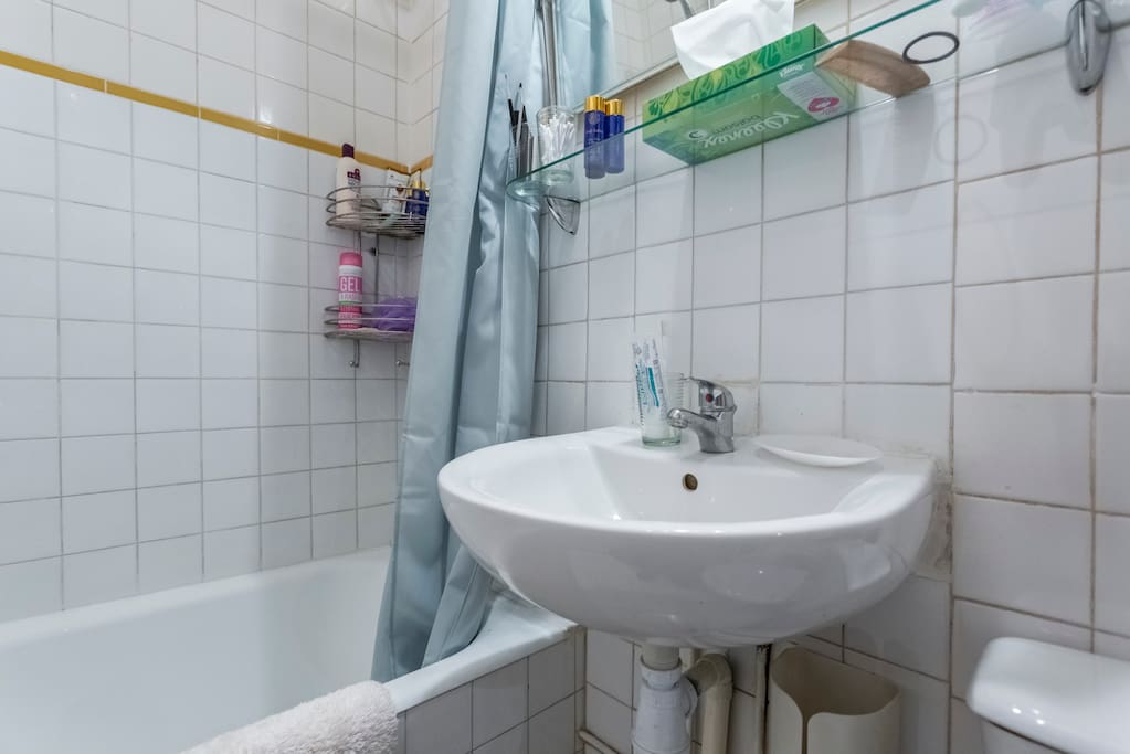 The bathroom with a nice bath tub and everything you need (candles and bath soap) to take a nice bath
