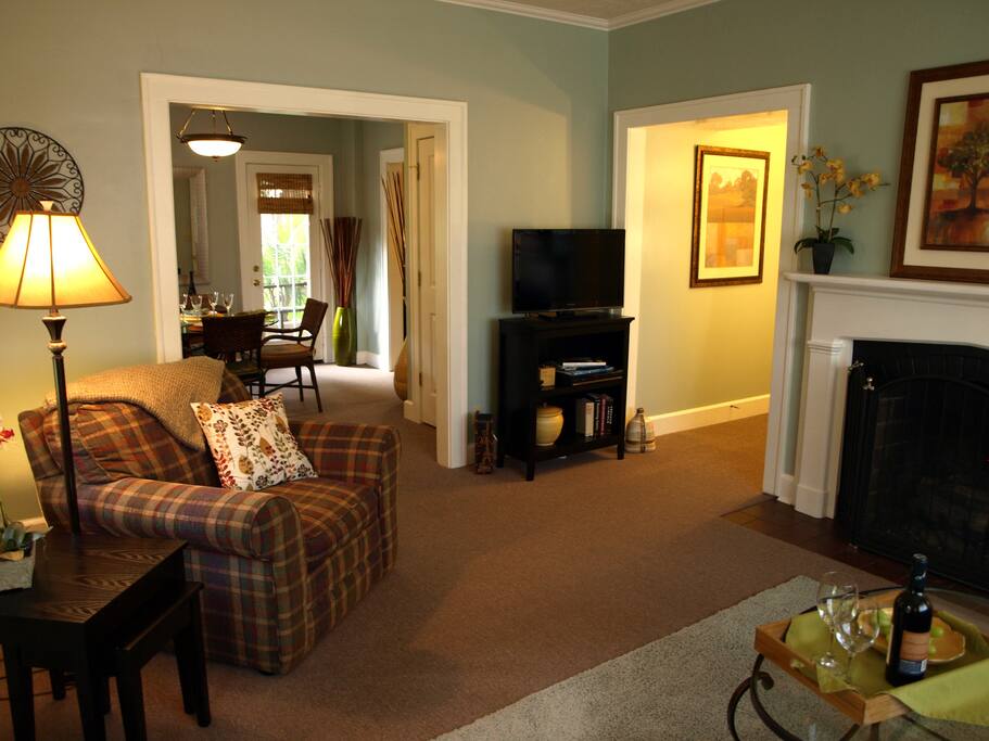 Living room looking into dining area and hall to bath and bedroom