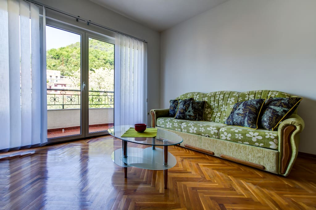 Living room wit sofa bed and balcony view
