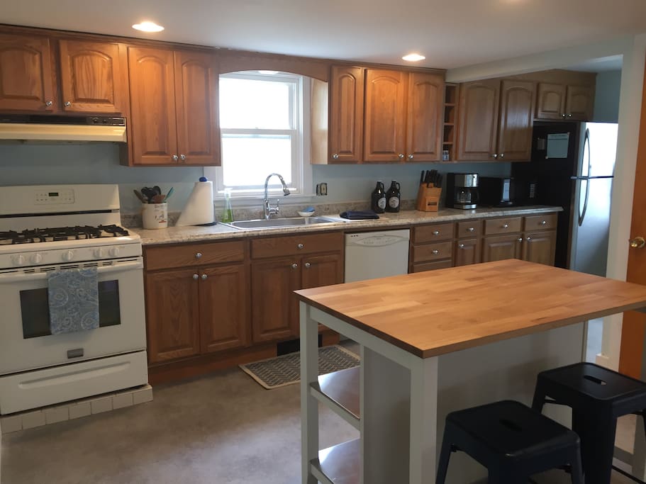 Kitchen with island, 2 stools, large pantry closet for storage. Stocked for dining in.