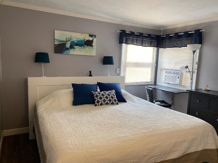 The Master bedroom boasts a king size bed, roomy dresser, and work space.