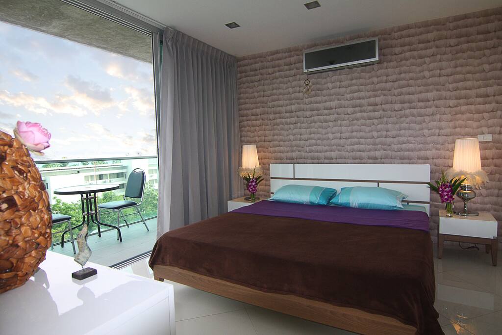 Spacious bedroom with king-size bed, on-suite bathroom, and sea-views balcony