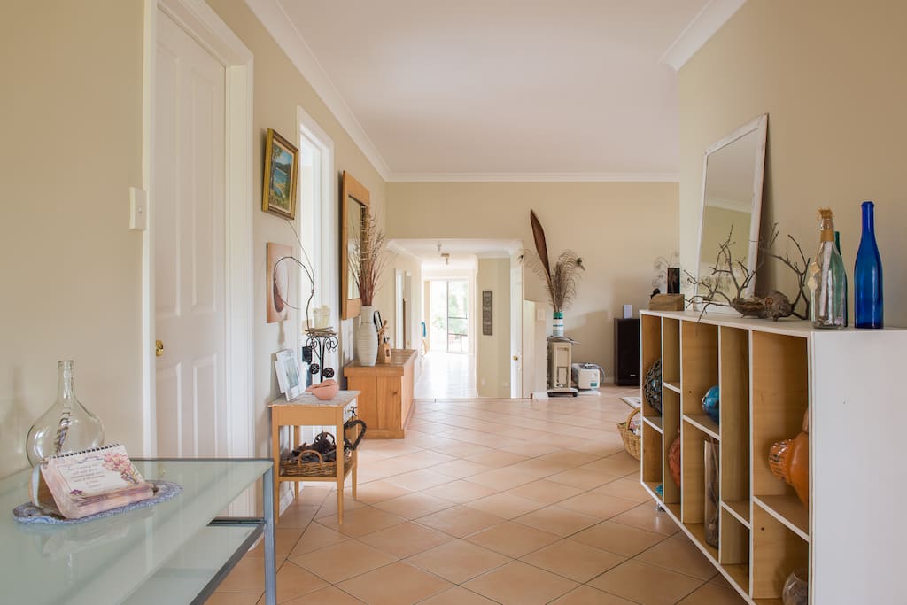 Entrance hallway. Bed 1 on right before bookshelf, Bed 2 on left, upstairs lounge room on right past bookshelf, 4 stairs down to rest of house.
