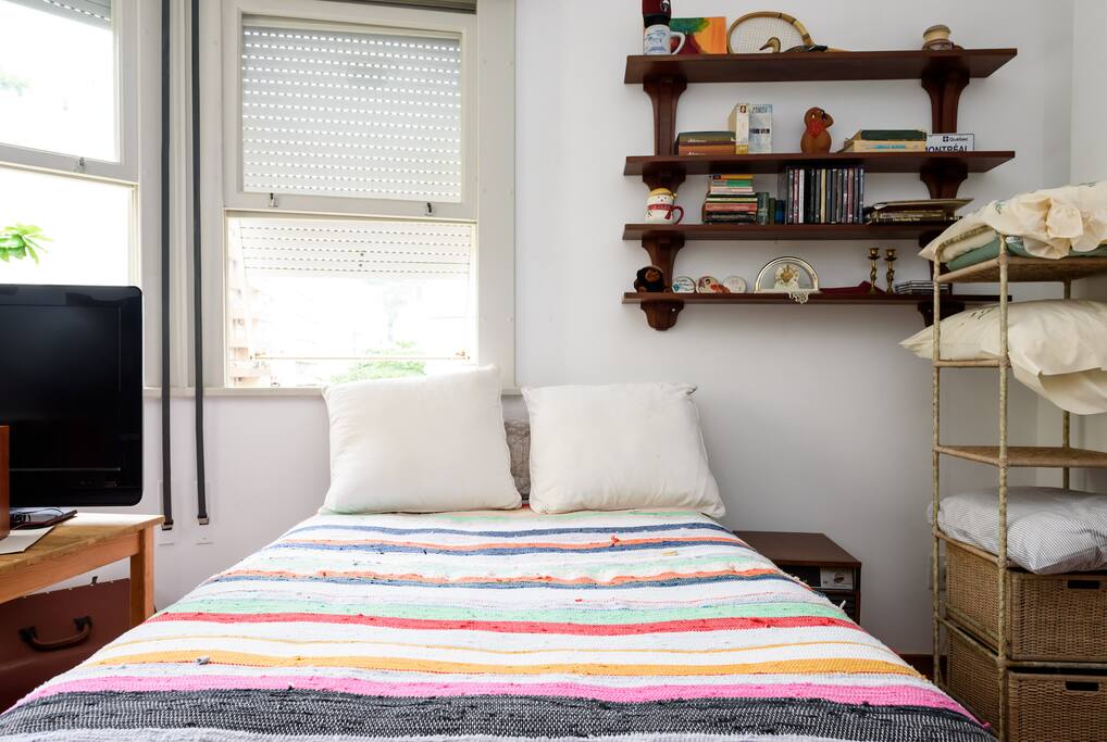 This is the guest room where you will be staying, with big bay windows.