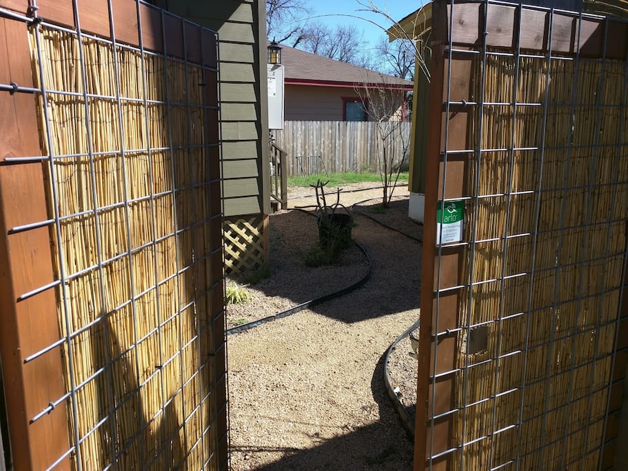 After entering thru side fence gate, walk in between my two airbnbs: Guest House (left) and Tiny House (right)