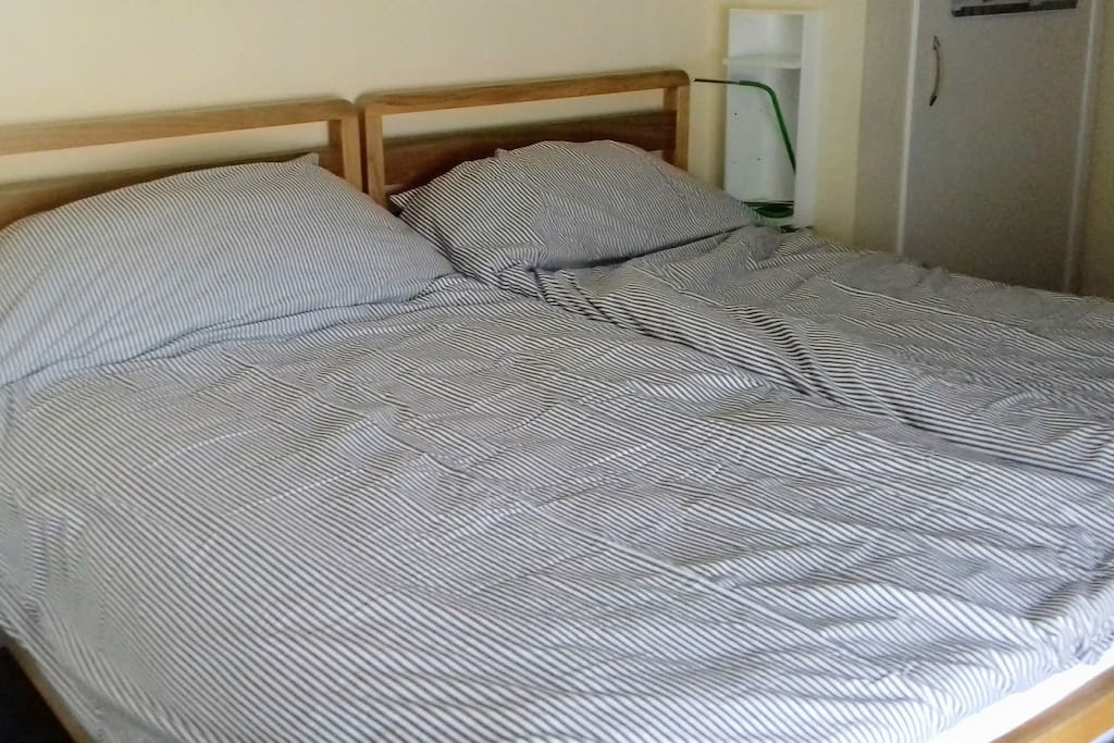 Super king-size bed with separate duvets.