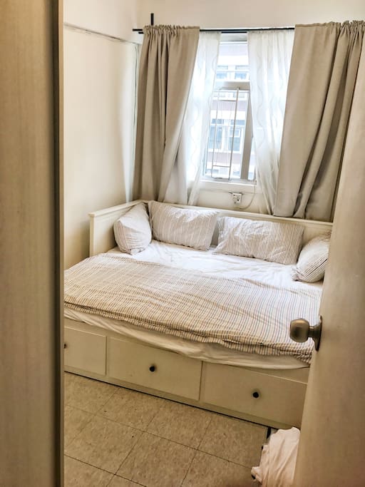 Bedroom from entrance view. King Size wheels out from single. 3 suitcases of storage underneth