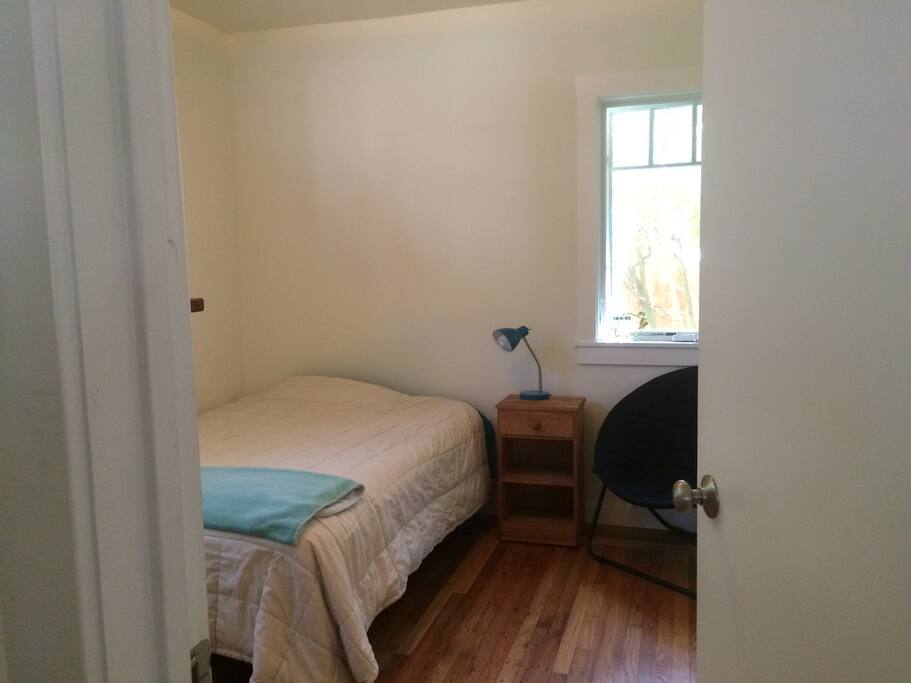 Sunny bedroom with double bed, large closet, dresser, night table, adjacent office nook.
