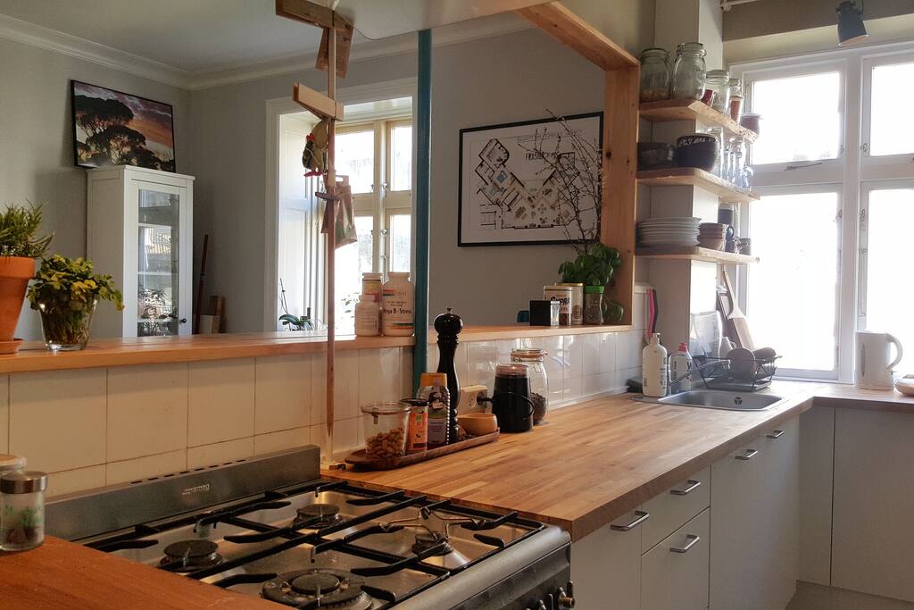The bright conversation kitchen - with a bar desk and three bar stools