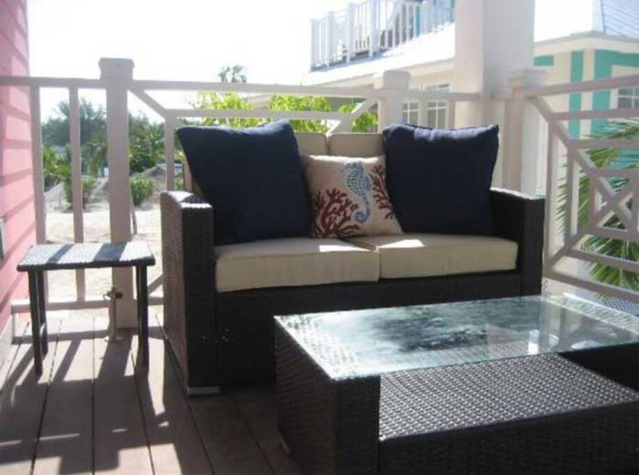 The Pink Villa features front and exterior porches, as well as a spacious second floor balcony.