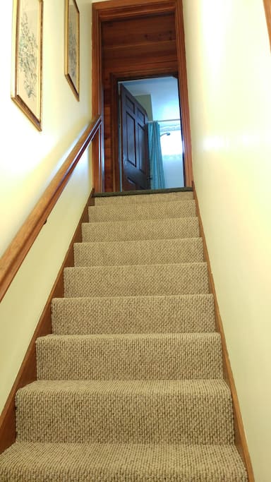 Stairs from the entry up to the Pine Cottage Guest Suite