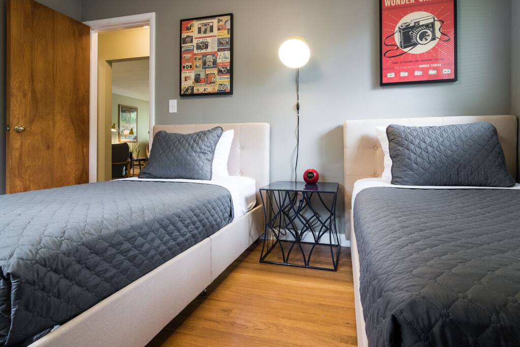 One bedroom with two twin beds featuring crisp new linens, new beds and matresses.