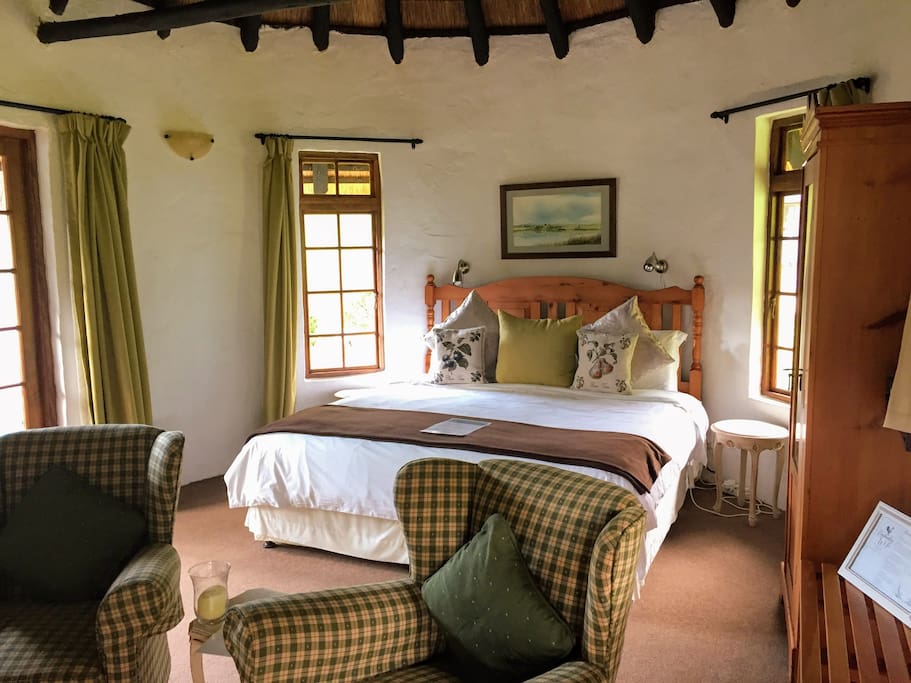 King Sized bed, seating area next to fireplace, tea and coffee facilities