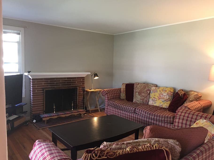 Comfortable family room space with working fireplace and HD TV