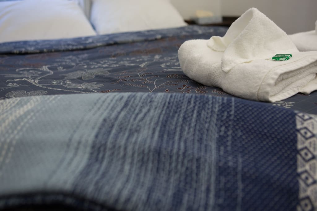 Luxury bed with premium sheets and towels