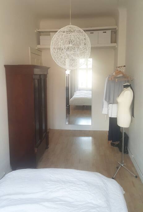 Quiet bedroom with clothes rail and hangers