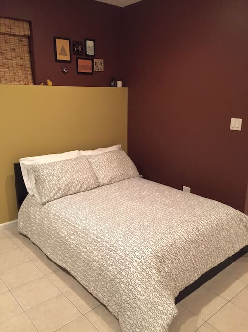 Full size bed with fresh linens.