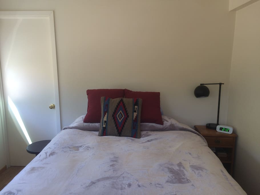 Queen size bed with overhead fan