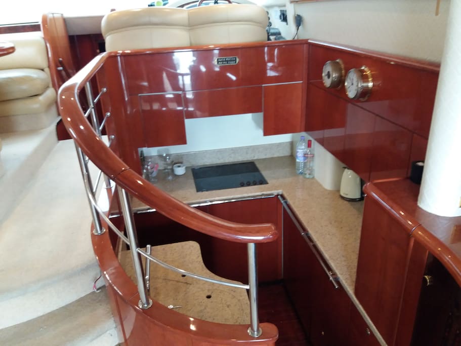 Galley, with utility room below, 6 climate control zones throughout. 4 ring halogen hob, microwave, fridge and freezer.