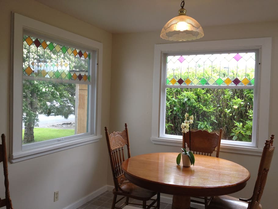 Kitchen eating area with original stained glass windows