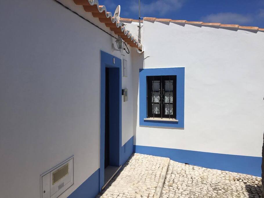 Kitchen entry off small cobbled walkway