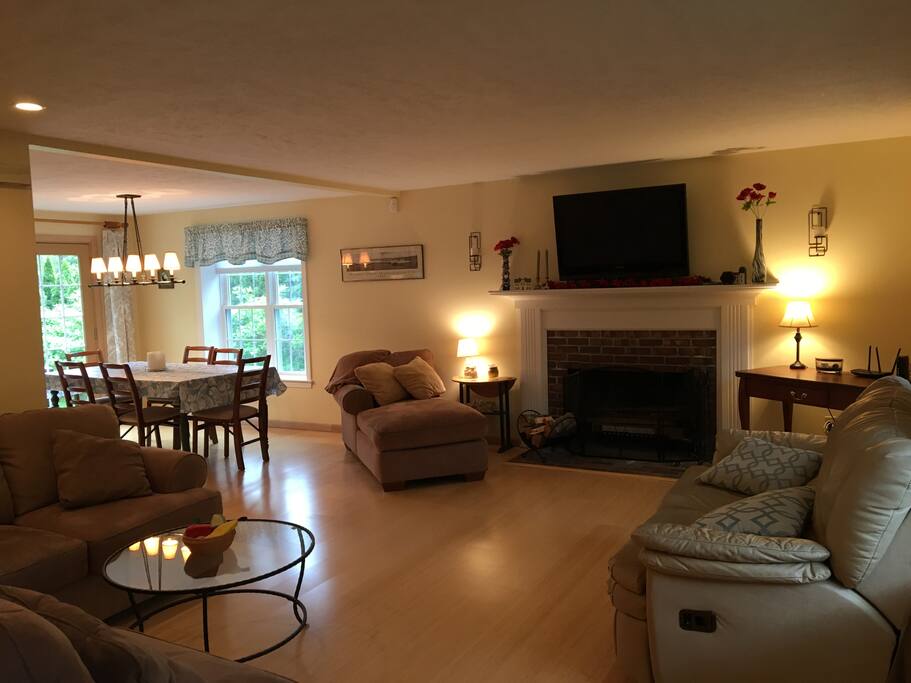 Living room from front door, with sectional couch, fireplace, TV