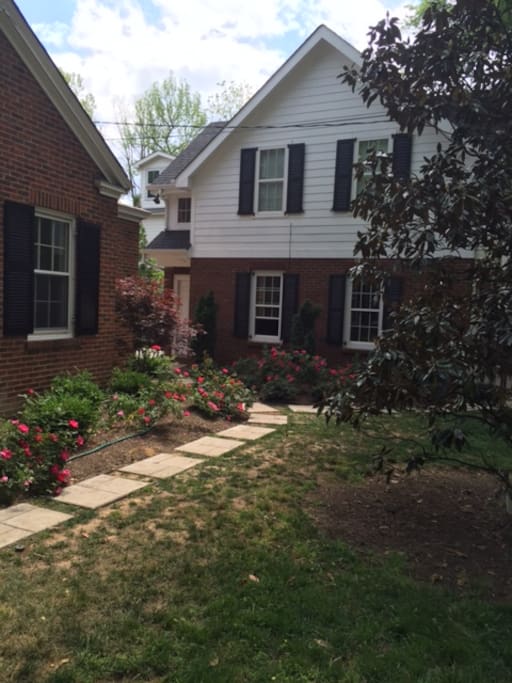 Inviting pathway through the rose garden to your Airbnb front door