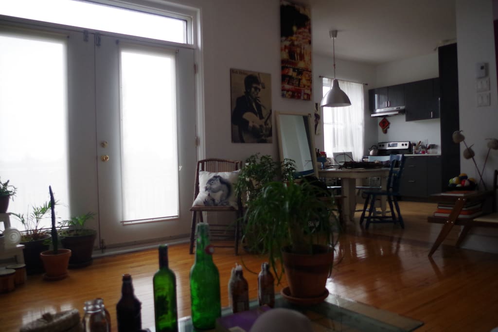 Living room has big open balcony and connects to kitchen.
