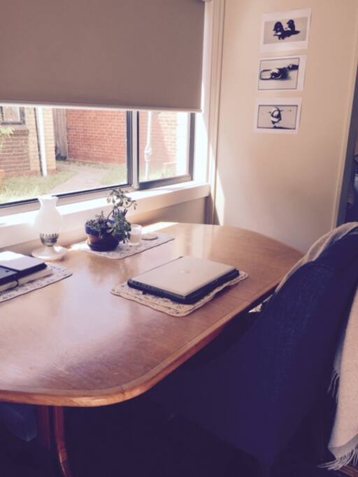 Extendable dining under sun-drenched window.
