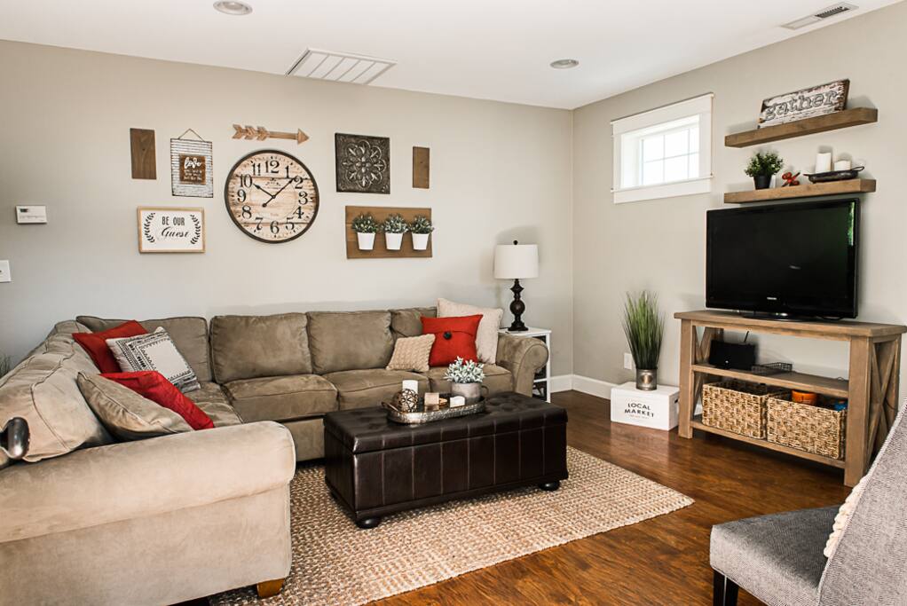 Sectional couch has pull out bed with bedding stored inside the ottoman.