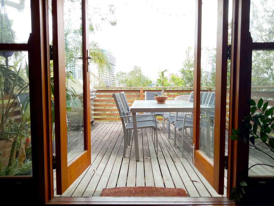 Lounge room looking out to deck and citu view beyond.