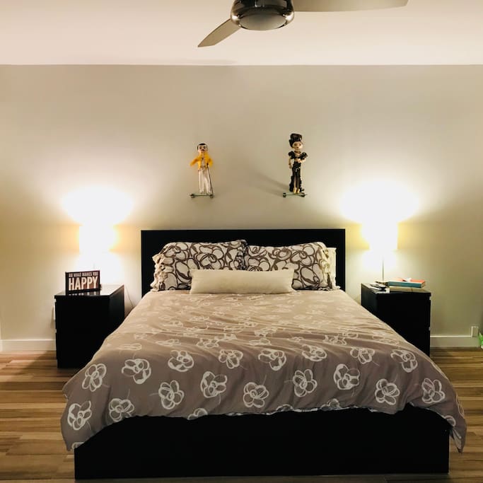 Comfortable queen sized bed, sleeps two. Hand stitched Carmen Miranda & Freddie Mercury figures are displayed overhead.