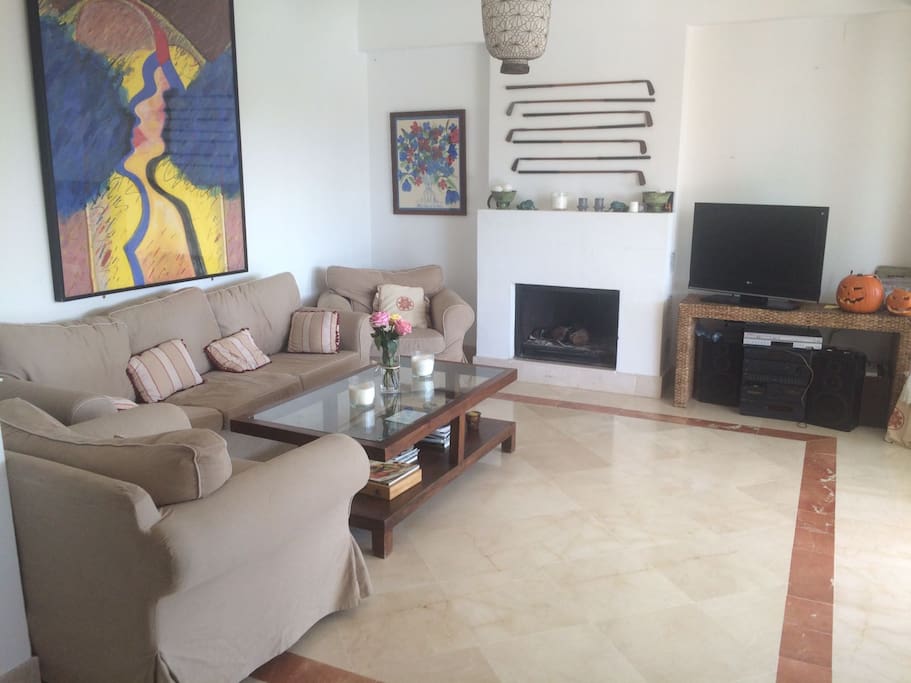 Welcome to our family apartment! Share the best moments of your stay in this cozy living room with chimney and an open dining area; both spaces are connected with glass doors to a big terrace.