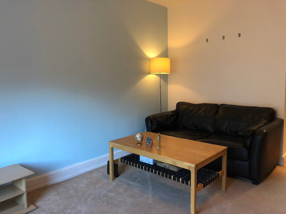 living room with a cozy corner :) tw人 seats leather sofa and tea tae for chill