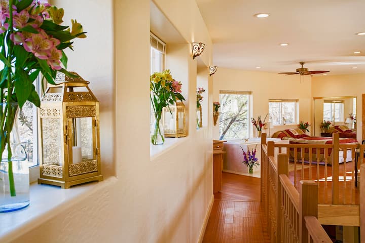 Walking the from the loft bedroom  to the master suite is a pleasant adventure. An executive desk for two is built into a by window at the end of the scenic wooden walkway. The whirlpool tub with a view is on the right.