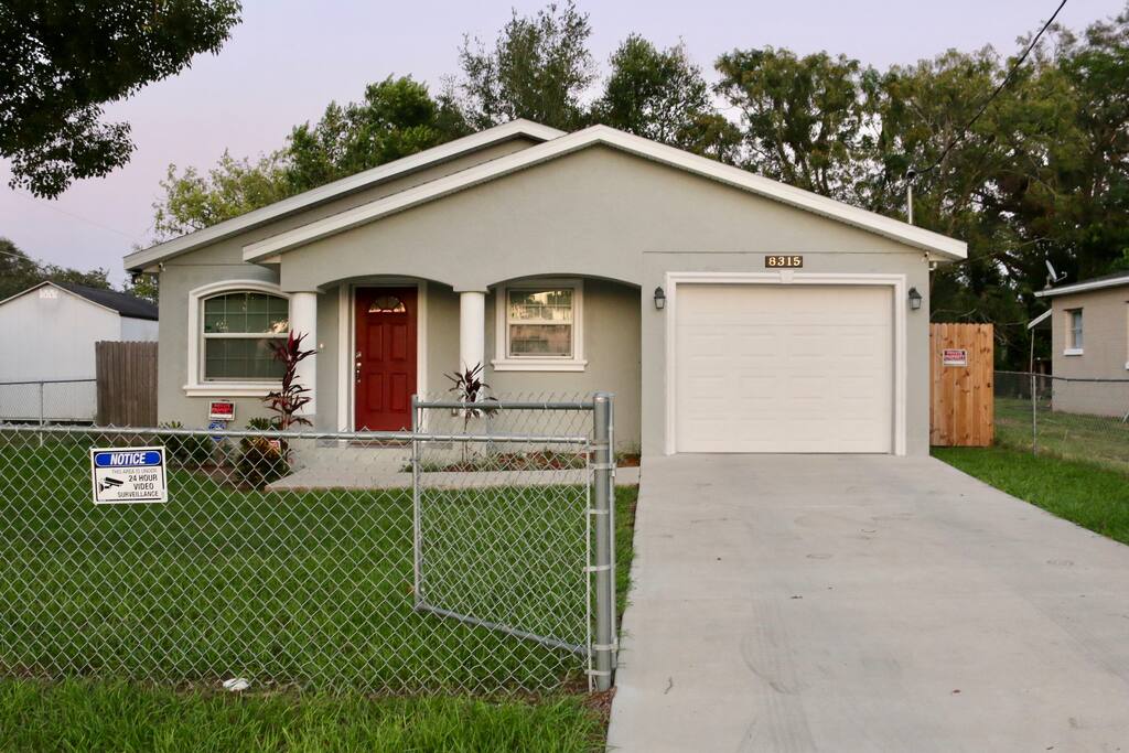 locked gate with a fenced front and back yard