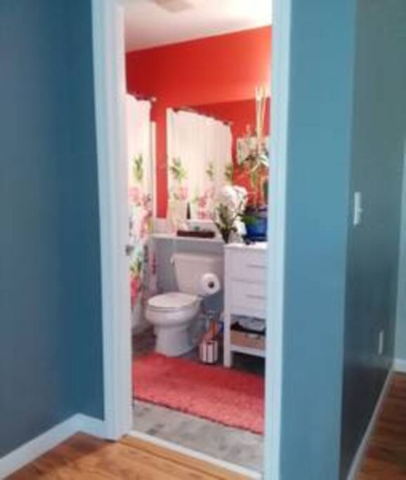 The bathroom is conveniently located across from the guest room. There are plenty of white towels and a large choice of toiletries.