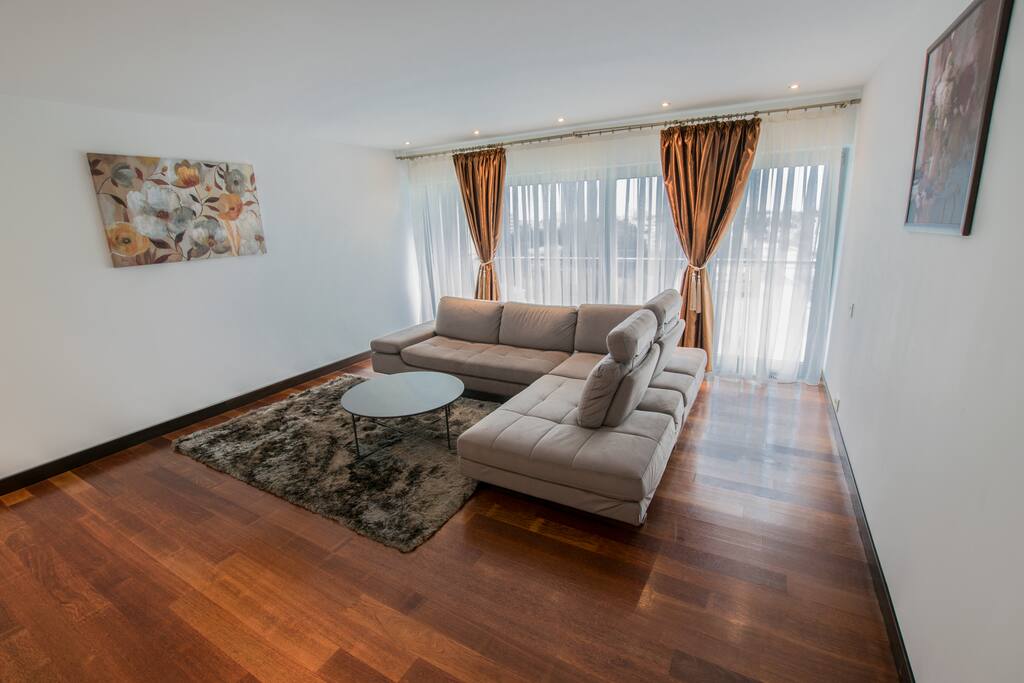 Bright living room with huge extensible sofa.