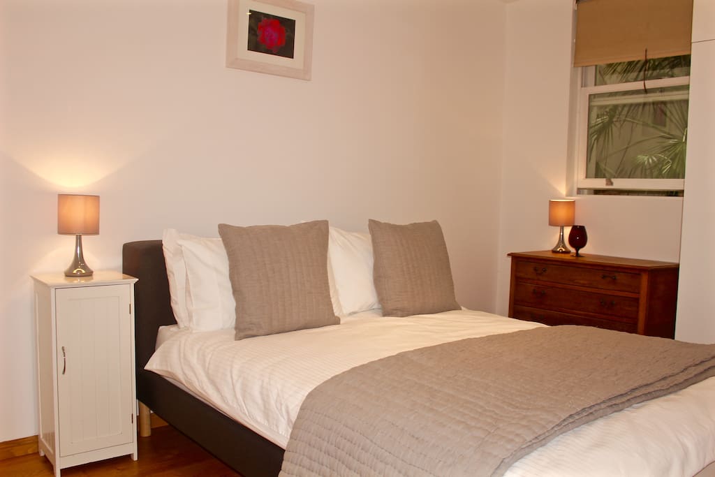 Bedroom with Queen sized double bed & ample storage.