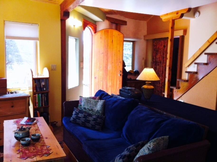 Living space, stairs to upper sleeping areas and bathroom downstairs.