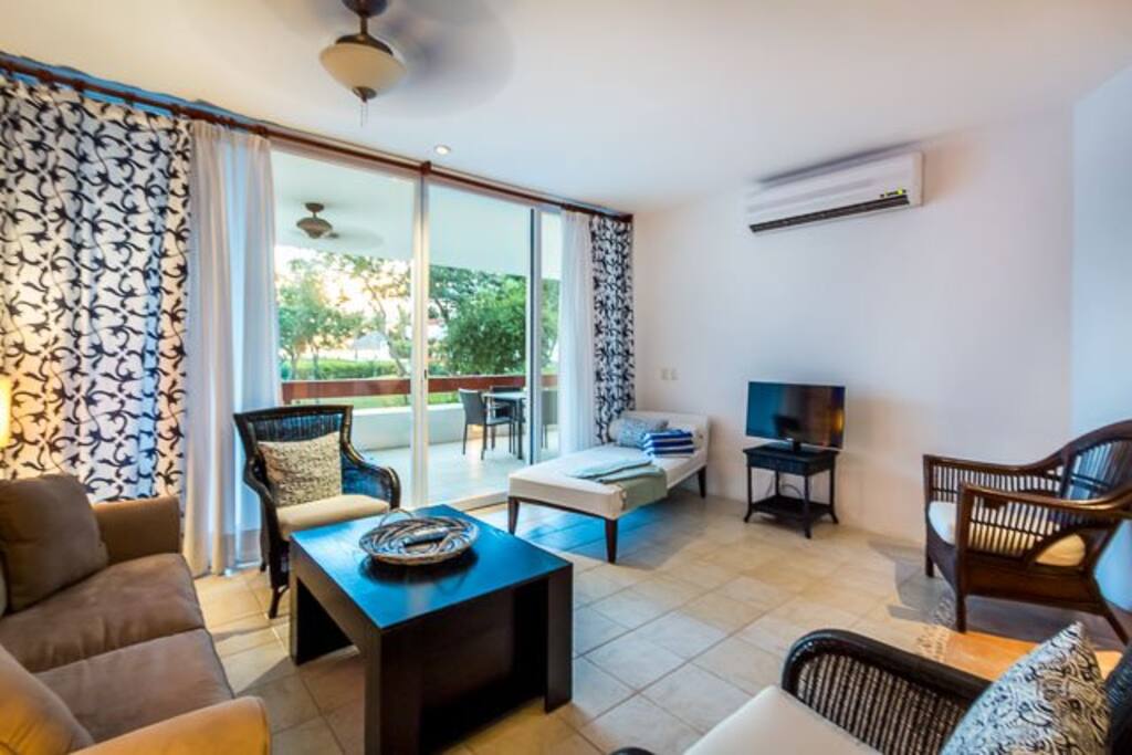The bright and colorful living area has a comfy couch and bonus pullout sleeper sofa