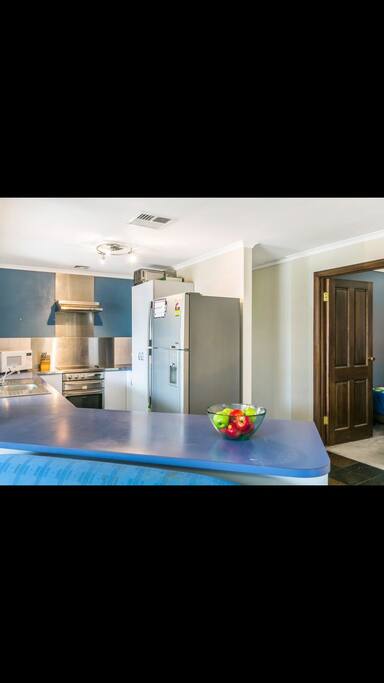 Open plan kitchen with plenty beanchtop to prepare family meal