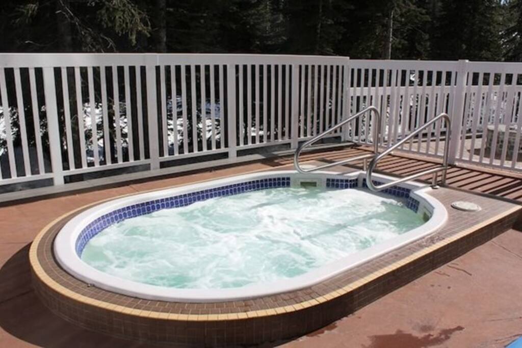 Relax and unwind after a day of skiing in the shared outdoor hot tub.