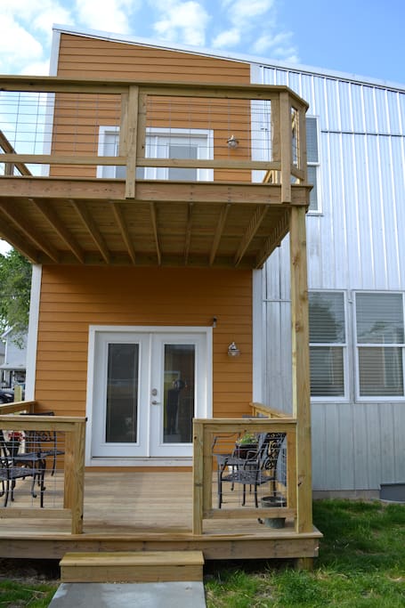 Rear of property. Fenced in back yard. Two decks. Large deck on 2nd floor off of Queen Guestroom. Faces South - Sunny all day!