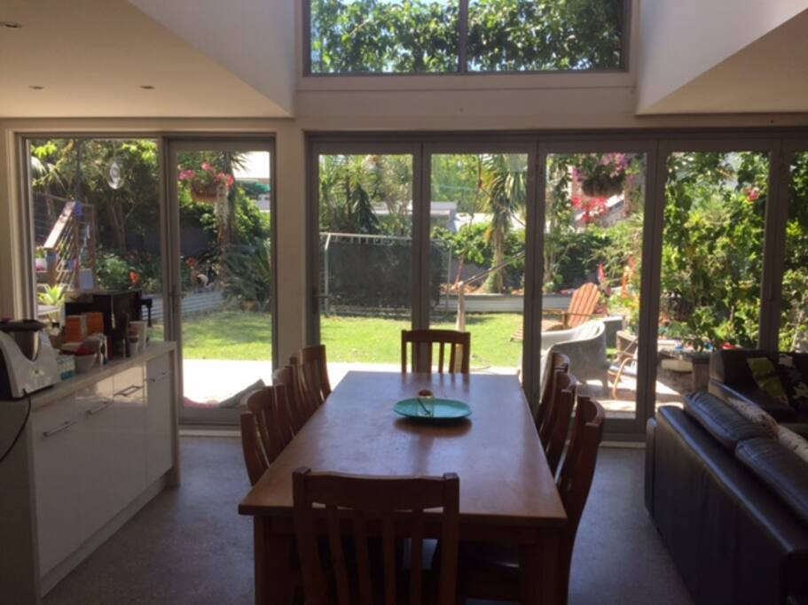 The open plan living room is a spacious area featuring polished concrete floors and bifold doors opening to a generous, sun filled garden. We have recently added outdoor sofa lounges to relax in the sunshine.