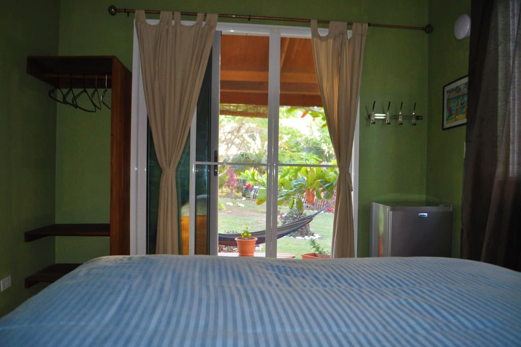 View from bed to terrace. As you can see there is a small closet with hangers to the left of the bed & a small fridge to the right.