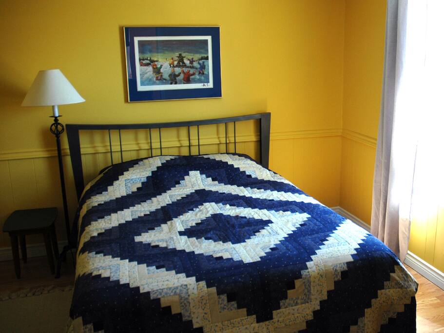 Comfy Queen Bed with Grandma's quilt