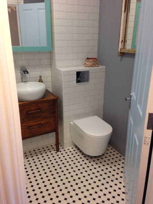 Bathroom with toilet, bathtub and shower facilities on first floor